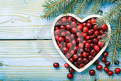 Cranberries on white tray on blue wooden background. Stock Photo