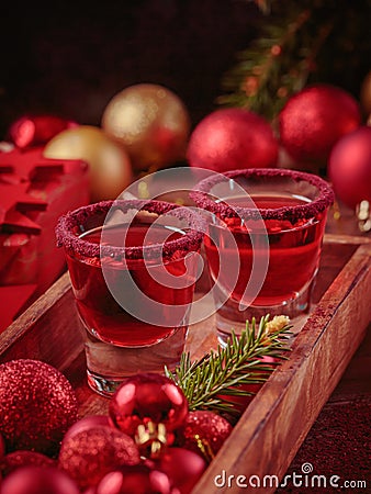 Cranberry vodka shot and Christmas decorations Stock Photo