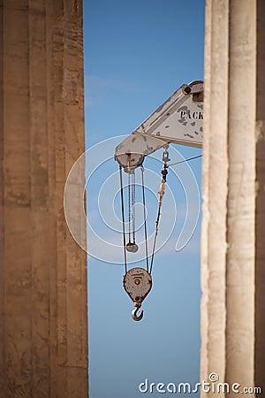 Crane appearing between two marble Parthenon columns Stock Photo