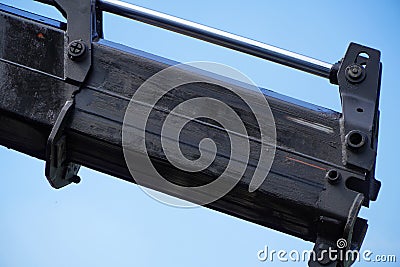 Crane boom with isolated hook, blue sky background,Elements of crane: hook, loop, chain, connecting parts Stock Photo