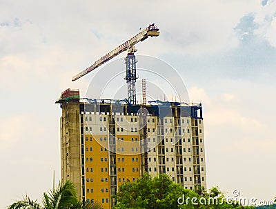 Crane at building construction with cloudy sky as background photo taken in Depok Indonesia Editorial Stock Photo