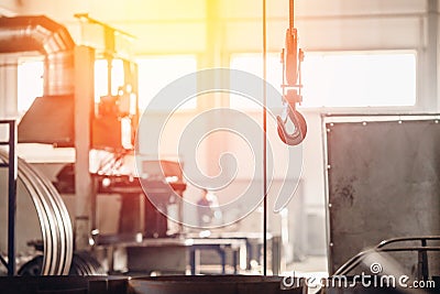 Crane chain and hook with blurred warehouse background. Concept production steel factory Stock Photo