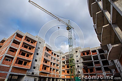 Crane construction bricks concrete building in city Stock Photo