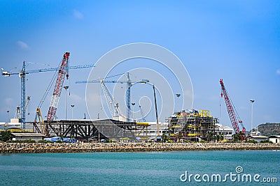 Crane Construction port for container ship in export and import business and logistics at harbor industry coast Editorial Stock Photo