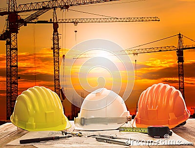 Crane in construction site and working table of civil engineer w Stock Photo