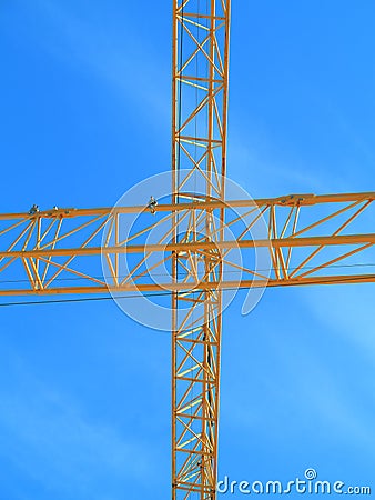 Yellow crane cross in blue sky Stock Photo