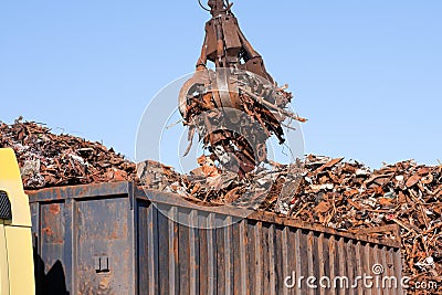 Crane grabber loading a Truck with metal scrap Stock Photo