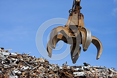 A crane grabber up on the metal heap Stock Photo