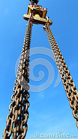 crane hook and big chain under blue sky Stock Photo