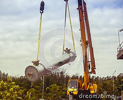 Crane lifting equipment for installation in chemical plant Stock Photo