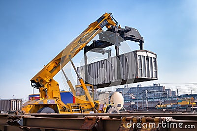 Crane lifts a container loading a train Stock Photo