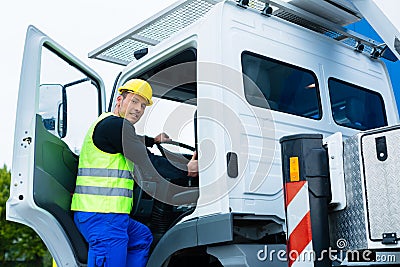 Crane operator driving with truck of construction site Stock Photo