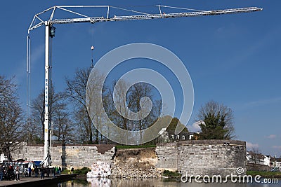 Crane truck trying to help rescuing a collapsed fortified city wall Editorial Stock Photo