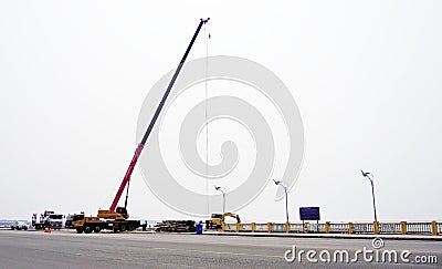 Crane truck working at road side Editorial Stock Photo