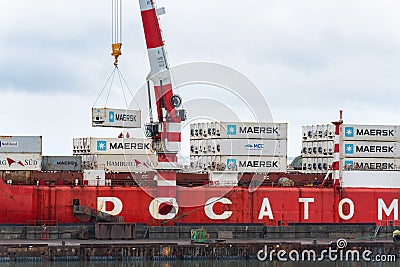 Crane unloading Russian container ship Sevmorput - nuclear-powered icebreaker lighter aboard ship carrier. Container Editorial Stock Photo