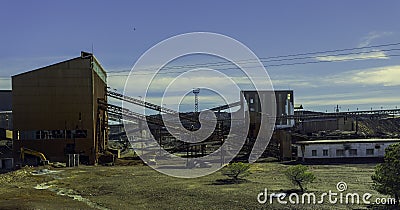 Cranes and buildings under the sunlight and a blue sky at daytime in Riotinto Mines in Spain Stock Photo