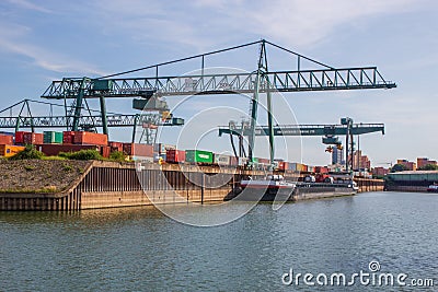 Cranes,containers and cargo around the Rhine river in the industrial port of Cologne North Rhine Westphalia Germany Editorial Stock Photo