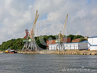 Cranes and industrial buildings in Liepaja harbor Editorial Stock Photo