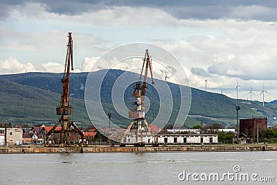 cranes in an old small industrial port on the Danube river Stock Photo