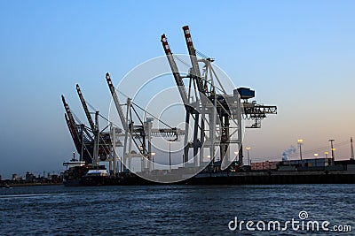 Cranes in the port of Hamburg at dusk Stock Photo