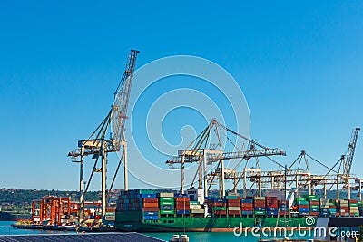 Cranes unloading a ship in a harbor. Koper, Slovenia - 27.07.2019 Editorial Stock Photo