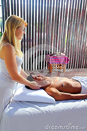 Cranial sacral massage theraphy in Jungle cabin Stock Photo