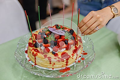 Crape Cake on top with Mixed Berries and Strawberry Sauce Stock Photo