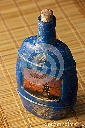 Craquelure decoupage bottle on a mat Stock Photo