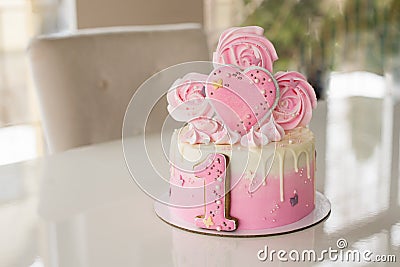 Crash pink cake at the celebration of the first birthday of the girl, ruined sponge cake, broken marshmallow, 1 year Stock Photo