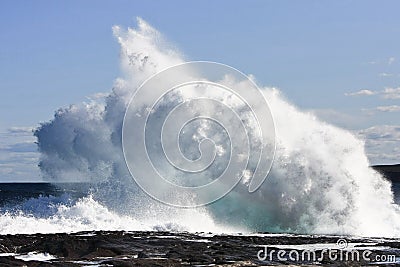 Crashing waves on rock ledge Stock Photo