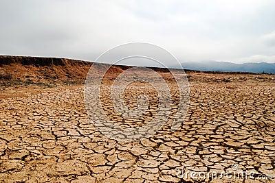 Crater from exploded cluster bomb with dried soil in Xieng Khouang Province, Laos. Stock Photo