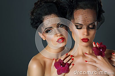 Craving. Aspiration. Two Seductive Fervent Women with Flowers Stock Photo