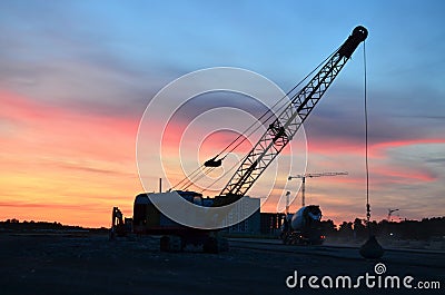 Crawler crane with a heavy metal wrecking ball on a steel cable. Wrecking balls at construction site. Dismantling and demolition Stock Photo