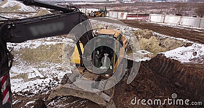 Crawler excavator working at the construction site. Construction machinery for excavating, loading, lifting and hauling Stock Photo