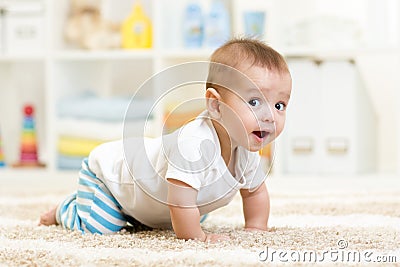 Crawling baby boy indoors Stock Photo