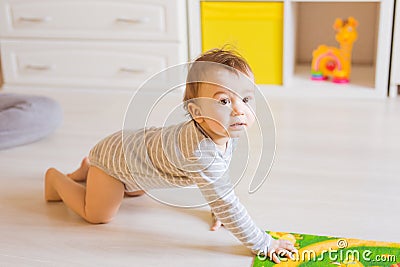 Crawling funny baby boy indoors at home Stock Photo