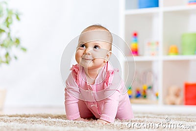 Crawling funny baby indoors at home Stock Photo