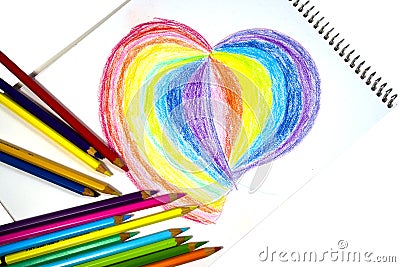 Crayons and heart on notebook Stock Photo