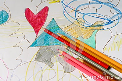 Crayons lying on a paper with heart drawing Stock Photo