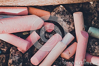 Crayons on the stones pink, mint, grey, brown Stock Photo