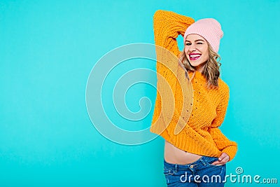 Crazy beautiful trendy girl with cheeky smile in colorful clothes and pink beanie hat. Attractive cool young woman portrait. Stock Photo