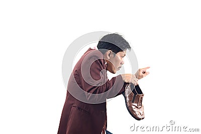 Crazy businessman holding shoes and try to sneak back in, do not Stock Photo