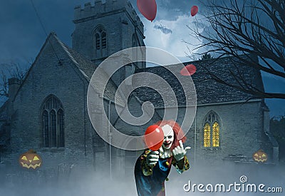 Crazy clown with a balloon in a gloomy scene of an old church Stock Photo