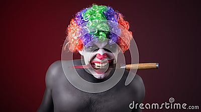 Crazy clown with a knife Stock Photo