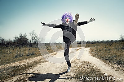 Crazy clown on the road Stock Photo