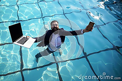 Crazy comic business. Funny businessman in suit with laptop and mobile phone on swimming pool. Stock Photo