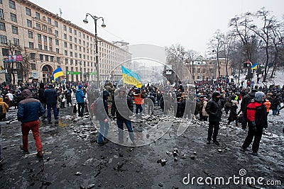 Crazy crowd of protesters walking in the burned square after fight with police in capital during anti-government riot in Kiev Editorial Stock Photo