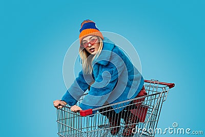 Crazy female in shopping cart Stock Photo