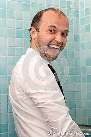 Crazy humorous portrait of business man in shirt in shower Stock Photo