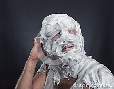 Crazy man with face completely in shaving foam Stock Photo